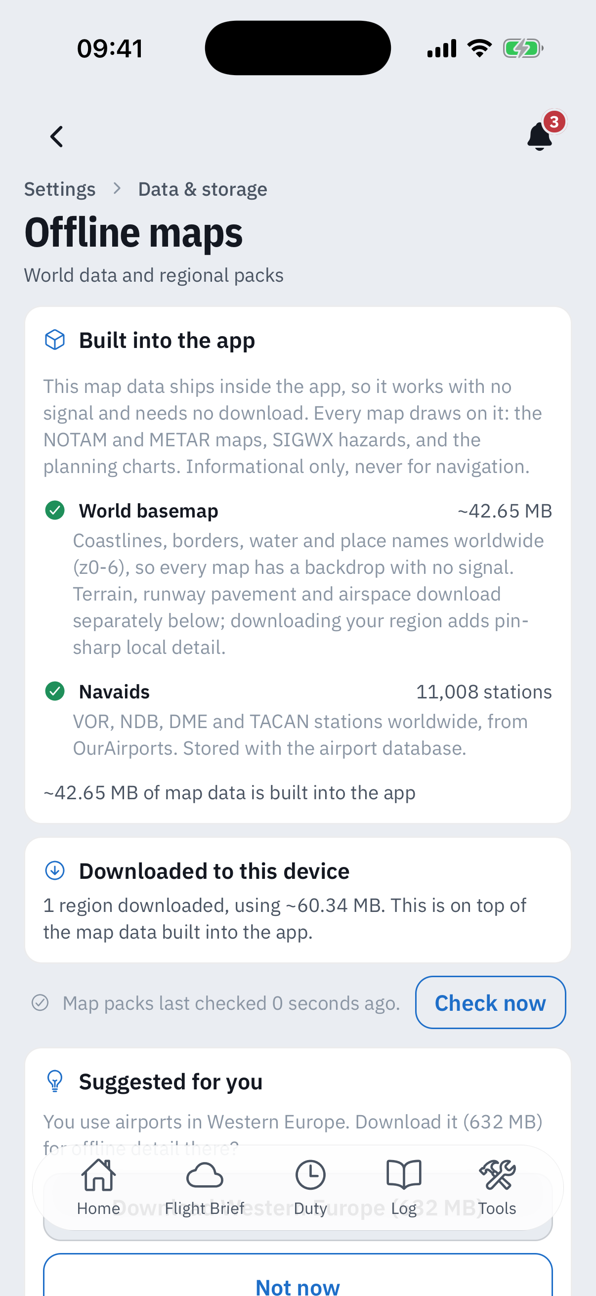 The Offline maps screen: a Built into the app card listing the World basemap at about 42.65 MB with coastlines, borders, water and place names worldwide, and Navaids with 11,008 VOR, NDB, DME and TACAN stations from OurAirports, then a Downloaded to this device card reading 1 region downloaded using about 60.34 MB, a Map packs last checked line with a Check now button, and the top of a Suggested for you card offering Western Europe